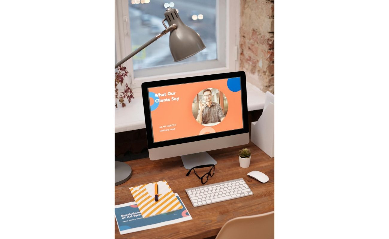 Stylish home office setup with computer showcasing client testimonials.